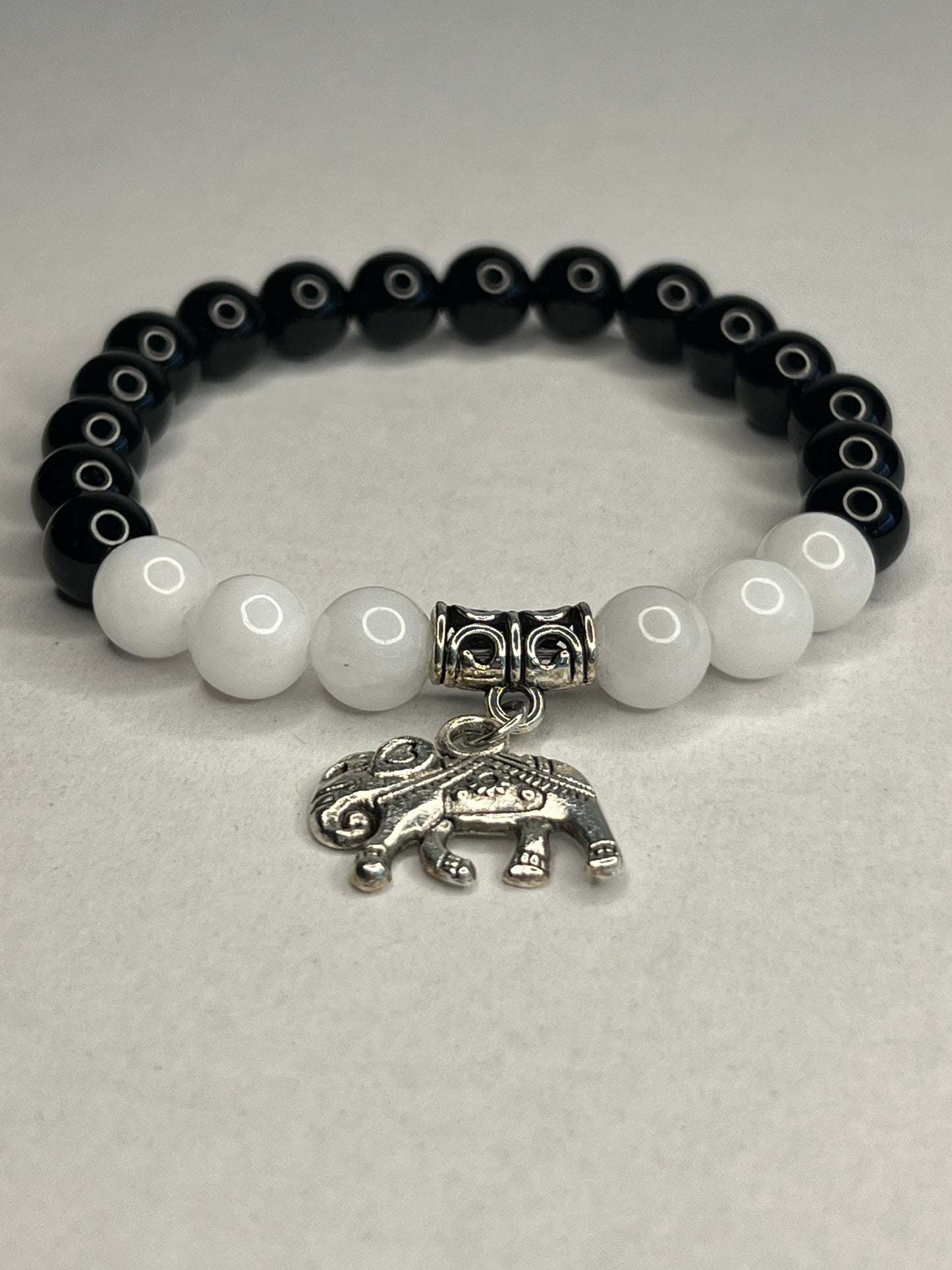Obsidian with Pure white quartz and steel elephant charm